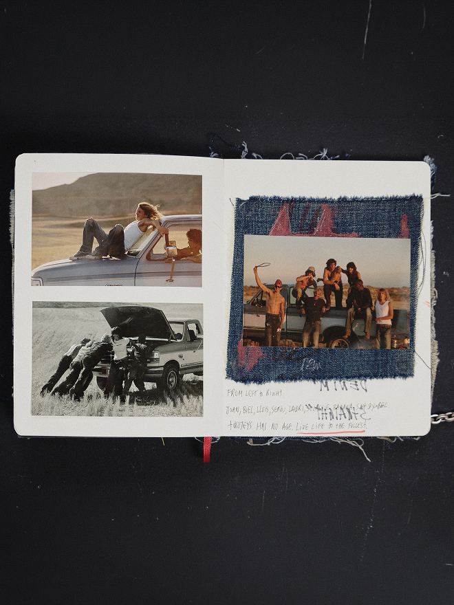 An open handmade journal or notebook on a black background, showing two collage-filled pages with embedded photographs, fabric textures, and handwritten text.